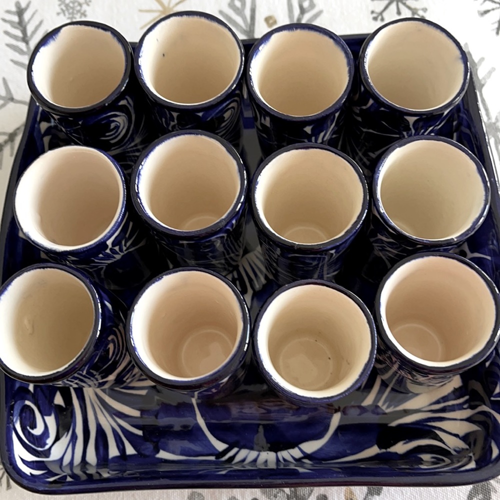 12 ceramic shot glasses in ceramic tray in blue and white design. Made in Mexico